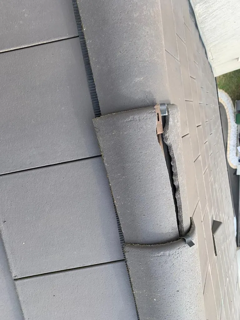 Tuile de faîtage cassée sur une toiture